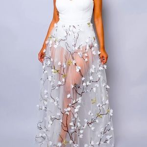 White dress with shear bottom with embroidered with a tree and flowers.